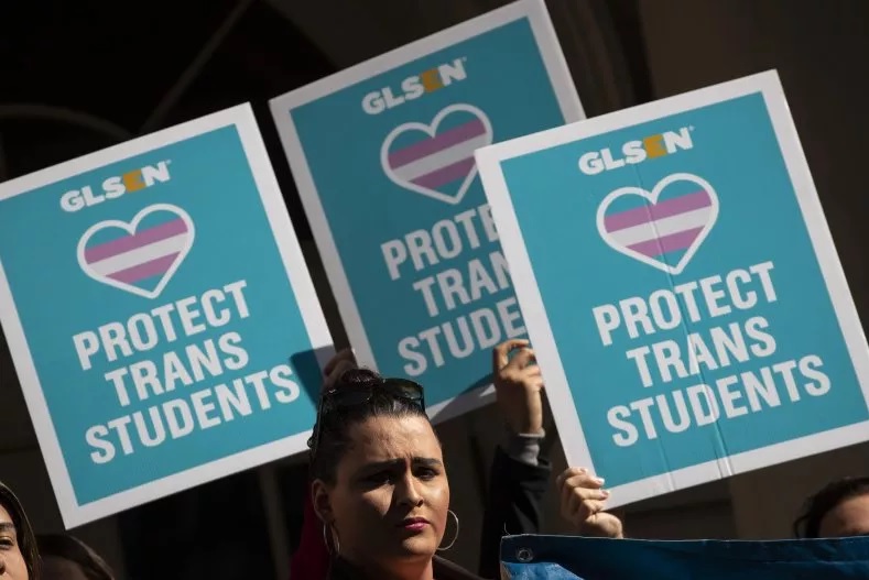 LGBT activists and their supporters rally in support of transgender students